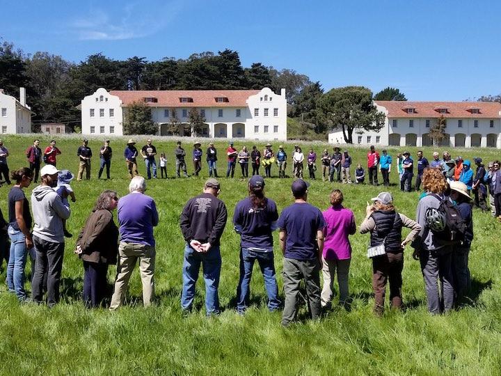 A large group of volunteers at Fort Scott in the Presidio.