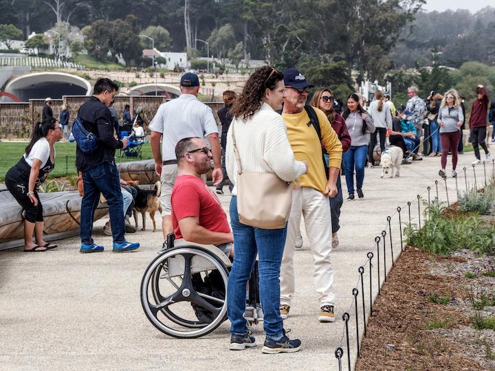 A group of visitors, including a man in a wheelchair, enjoy the view from Presidio Tunnel Tops. Photo by Dan Friedman.