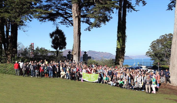 Group shot of Presidio Trust staff members posed on a large lawn.
