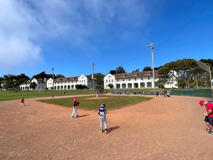 Young kids play baseball at Fort Scott Field.
