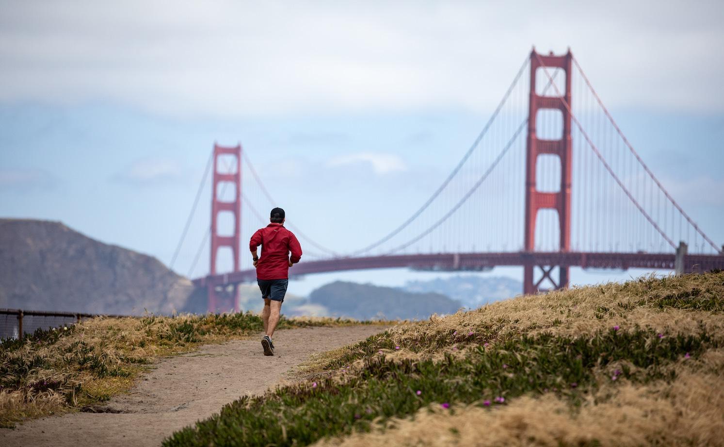 Man running with the Golden Gate Bridge in the background. Photo by Paul Myers.