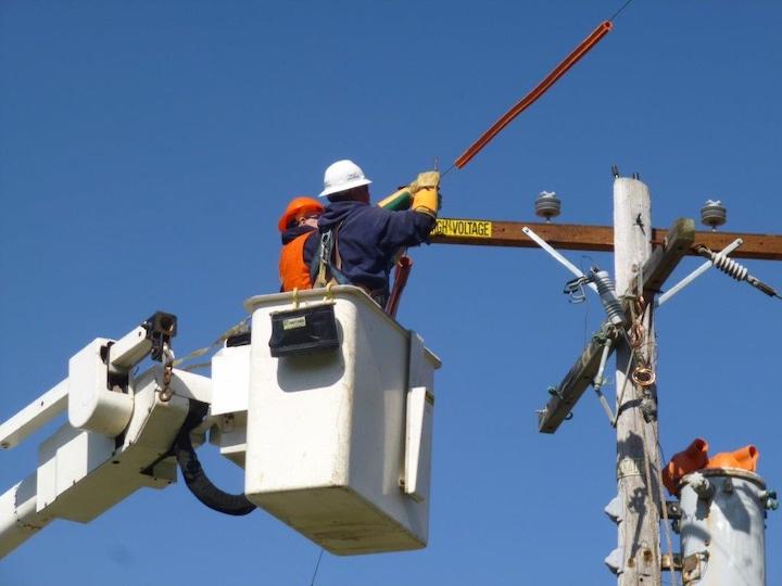 Presidio Trust High Volt staff member repairs a power line.