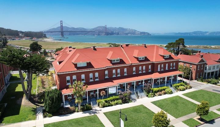 Lodge at the Presidio exterior, with the Golden Gate Bridge in the background.