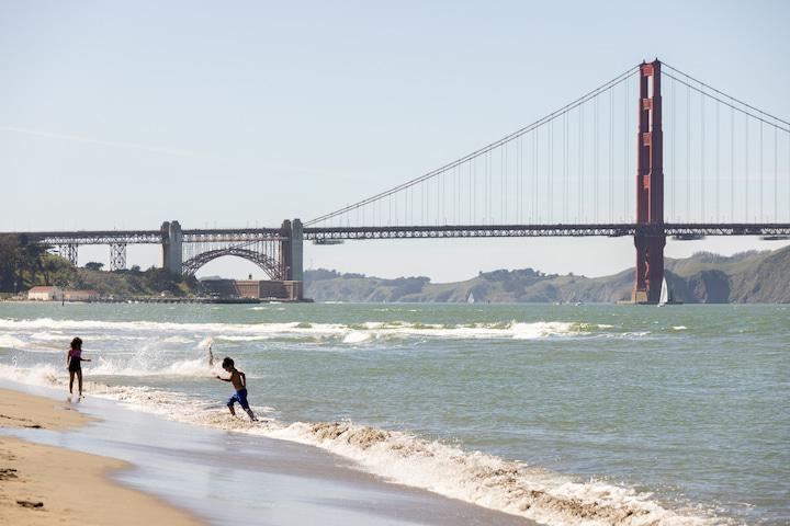 Two children play on the beach at East Beach Crissy Field.