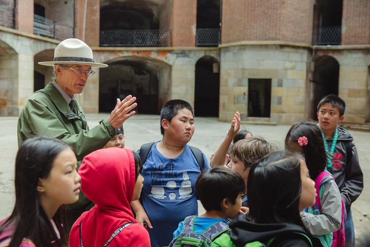 A Park Ranger speaks with kids at Fort Point. Photo by Erin Conger.