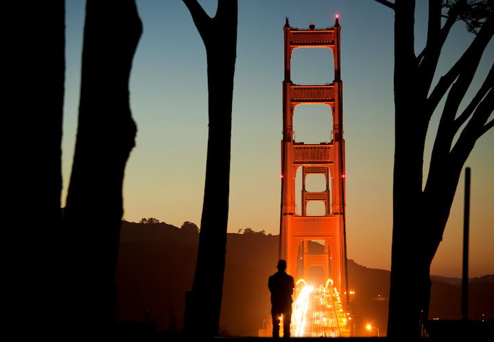 A man looks at the sunset over the Golden Gate Bridge from Golden Gate Overlook. Photo by Scott Sawyer.
