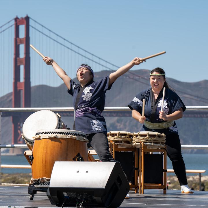 San Jose Taiko Drummers perform at the Presidio with the Golden Gate Bridge in the background.