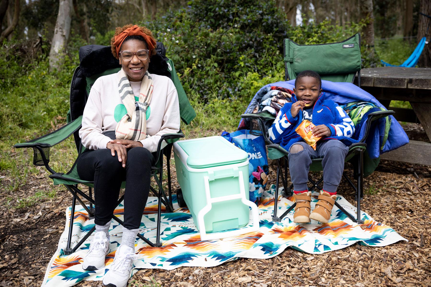 A woman and child sitting on chairs at Rob Hill Campground. Photo by Paul Myers.