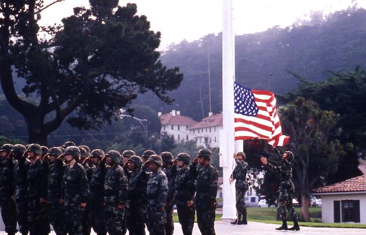 Soldiers lowering flag. Image courtesy Golden Gate NRA Park Archives.
