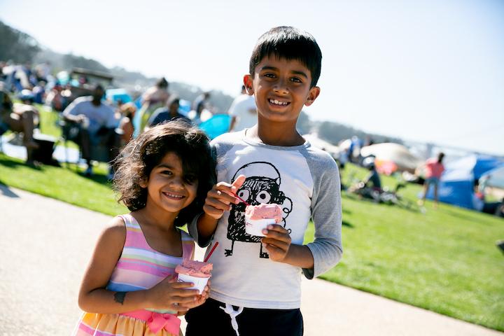 Young boy and girl holding ice cream.