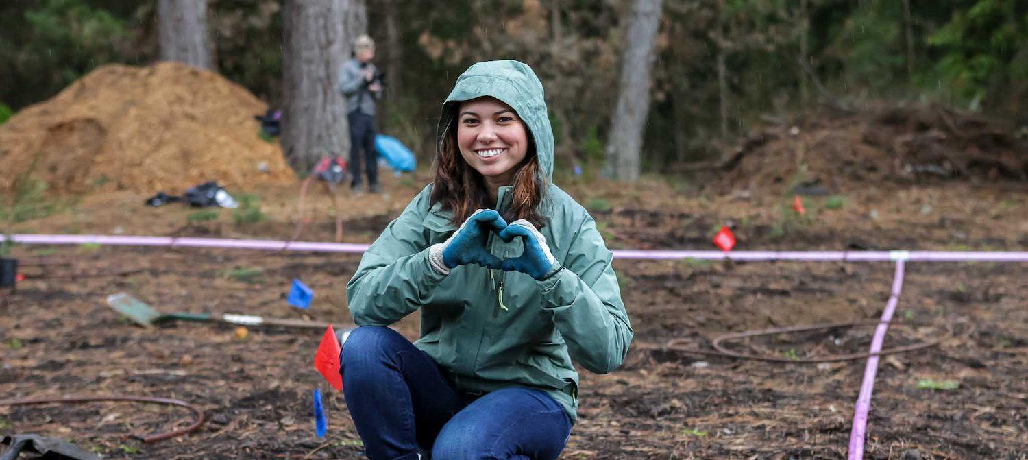 A volunteer makes a heart sign with her hands. Photo by Rob Lovato and Victor Aquino.