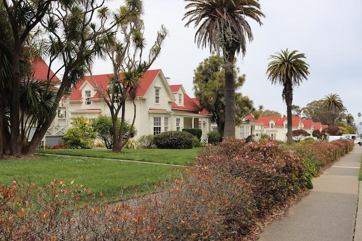 White homes with red roofs on historic Funston Avenue.
