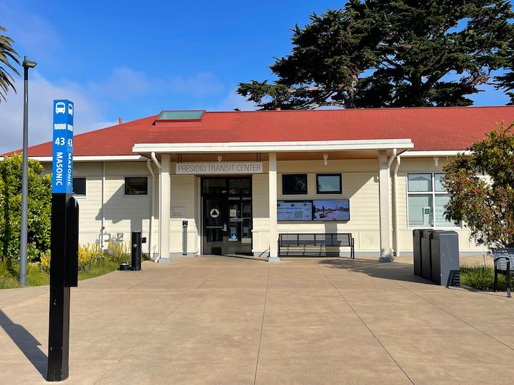 The front of the Presidio Transit Center on a sunny day with digital kiosks in front.