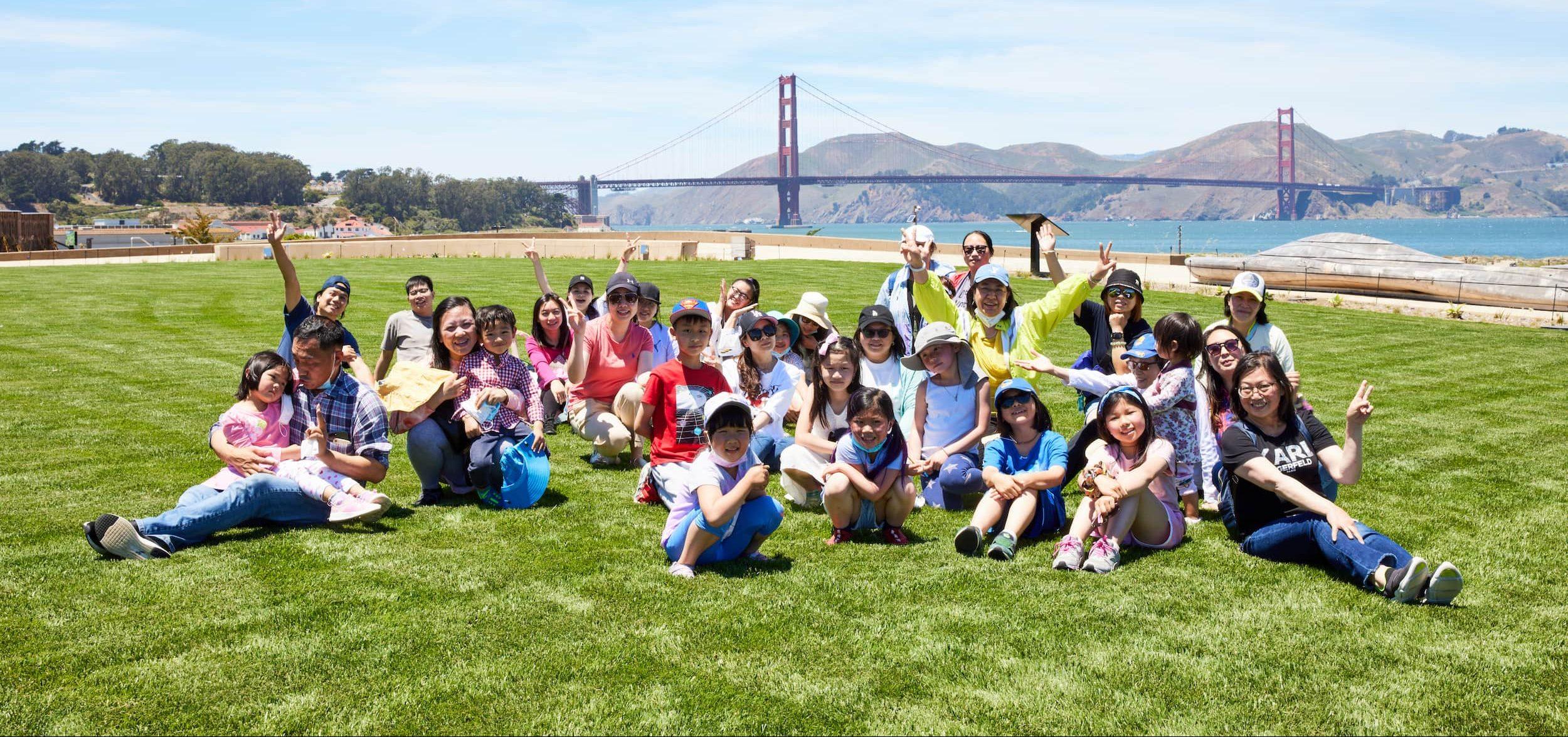 A large group of kids on a lawn at Presidio Tunnel Tops. Photo by Rachel Styer.