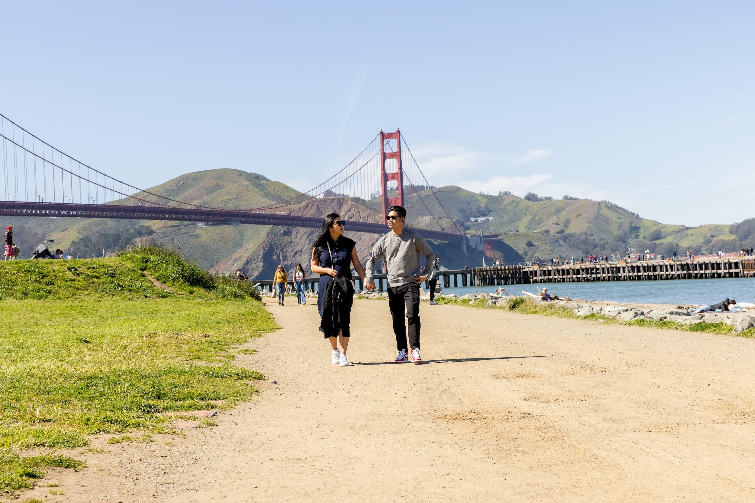 A man and a woman walk on a trail at Crissy Field. Photo by Myleen Hollero.