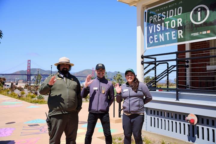 Representatives from the National Park Service, Parks Conservancy, and Presidio Trust standing in front of the Presidio Visitor Center