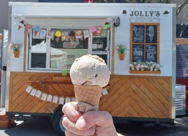 Ice cream cone held in front of Jolly's truck.